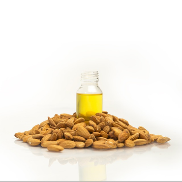 almond oil botte surrounded by almonds.